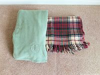 Both blankets side by side folded on carpet
