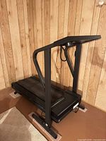 Side view of Weslo Cadence DX10 treadmill showing frame and running deck