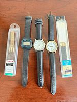 Group shot of all watches and packaged straps
