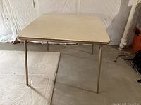 square beige laminate folding table with metal legs