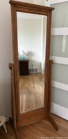 Full view of oak cheval mirror showing frame, glass, and stand