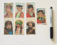 Seven cards front view with Sharpie for scale