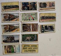 All 13 cigarette cards arranged face up showing illustrations