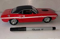 Driver side view of red 1970 Dodge Challenger diecast with Sharpie for scale