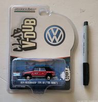 Front view of sealed GreenLight Club V-DUB 1974 Volkswagen Type 181 diecast package next to marker for scale