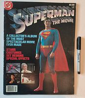 Front cover of oversized Superman The Movie treasury comic beside marker for scale