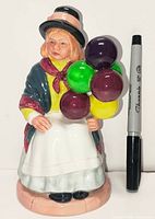 Front view showing full figurine next to Sharpie for scale