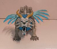 Front view of Death Liger figure showing head, horns, mane, rib wings and stance