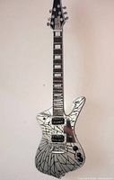 Front view of silver and black miniature guitar