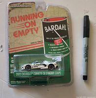Front of sealed Greenlight Running on Empty blister card with Corvette model and Sharpie for scale