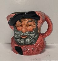Front view of the Royal Doulton Toby jug showing facial detail and colours