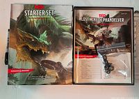 Closed box and contents displayed: box lid, adventure book, dice