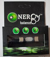 Front of retail package showing Energy Balance branding and wristband with hologram