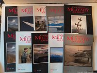 Ten Canadian Military Journal magazines arranged in two rows