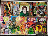All thirteen comic books laid out in two rows showing full covers and condition