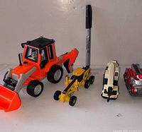 group shot of all four die-cast vehicles with scale reference