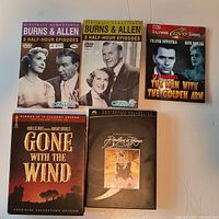 Front view showing all 5 DVD cases: two Burns & Allen volumes, The Man with the Golden Arm, Gone with the Wind collector’s edition, Breakfast at Tiffany’s collector’s edition