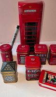 Group shot of all tins including tall telephone box, small tea tins, Big Ben, cylindrical and mint tin