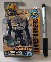 Front of packaged Barricade figure beside Sharpie for scale