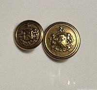 Front view showing both brass buttons and crest detail
