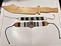 wooden knife and two bracelets overview