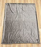 Full view of Indigo herringbone throw blanket laid flat