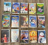 All 15 visible VHS tapes laid out showing front covers and cases