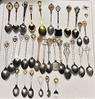 Full lot view of 36 spoons and 1 fork
