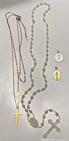 Full view of rosary, cross necklace and two pendants