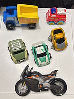 Top-down view of six toy vehicles showing design and condition