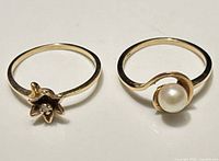 Both gold rings side by side, showing design fronts