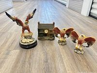 All four resin items: large eagle, cottage clock, two small eagles