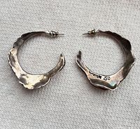 Front view of both sterling hoop earrings showing organic wavy shape and post backs
