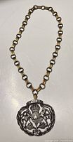 Full view of necklace showing chain and medallion