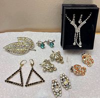 Group shot of entire lot displaying brooch, pendants, and four earring pairs