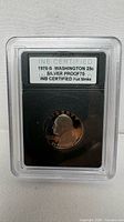 Front of INB slab showing obverse of 1976-S Washington quarter and certification label