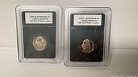 Front view of both encapsulated 1987-S Jefferson nickels