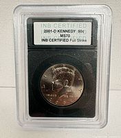 Front view of INB-slabbed 2001-D Kennedy half dollar showing label and coin