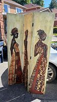 Front view of three-panel screen showing full Afrocentric artwork