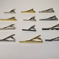 Top view of all twelve tie clips showing finishes and sizes