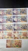 Nine Ghanaian Cedi banknotes laid out showing obverse designs and denominations