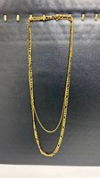 Full view of gold plated sterling silver double-strand necklace on black background