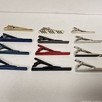 Top view showing all tie clips arranged on white surface