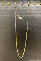 Full view of gold-plated sterling silver box chain hanging, clasp and extender visible