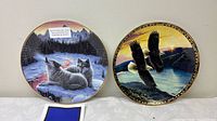 Front view of both wildlife plates displaying artwork and gold rims