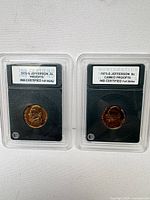 Front view of both slabbed Jefferson nickels with grade labels visible