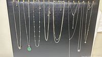 All seven necklaces hanging to show full length and style variety