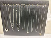Full view of all necklaces hung on display board