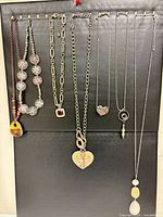 All eight necklaces displayed on board