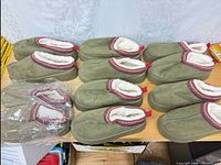 All six pairs of slippers, five unwrapped and one pair in original plastic